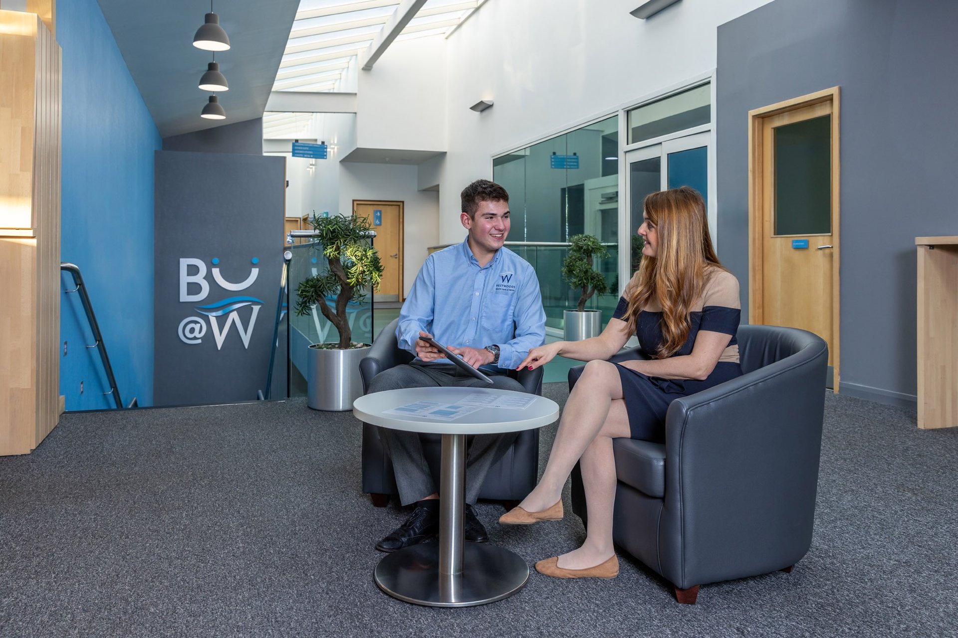 Sales manager and new member signing up to a membership on an ipad in café refresh at Westwoods Health Club