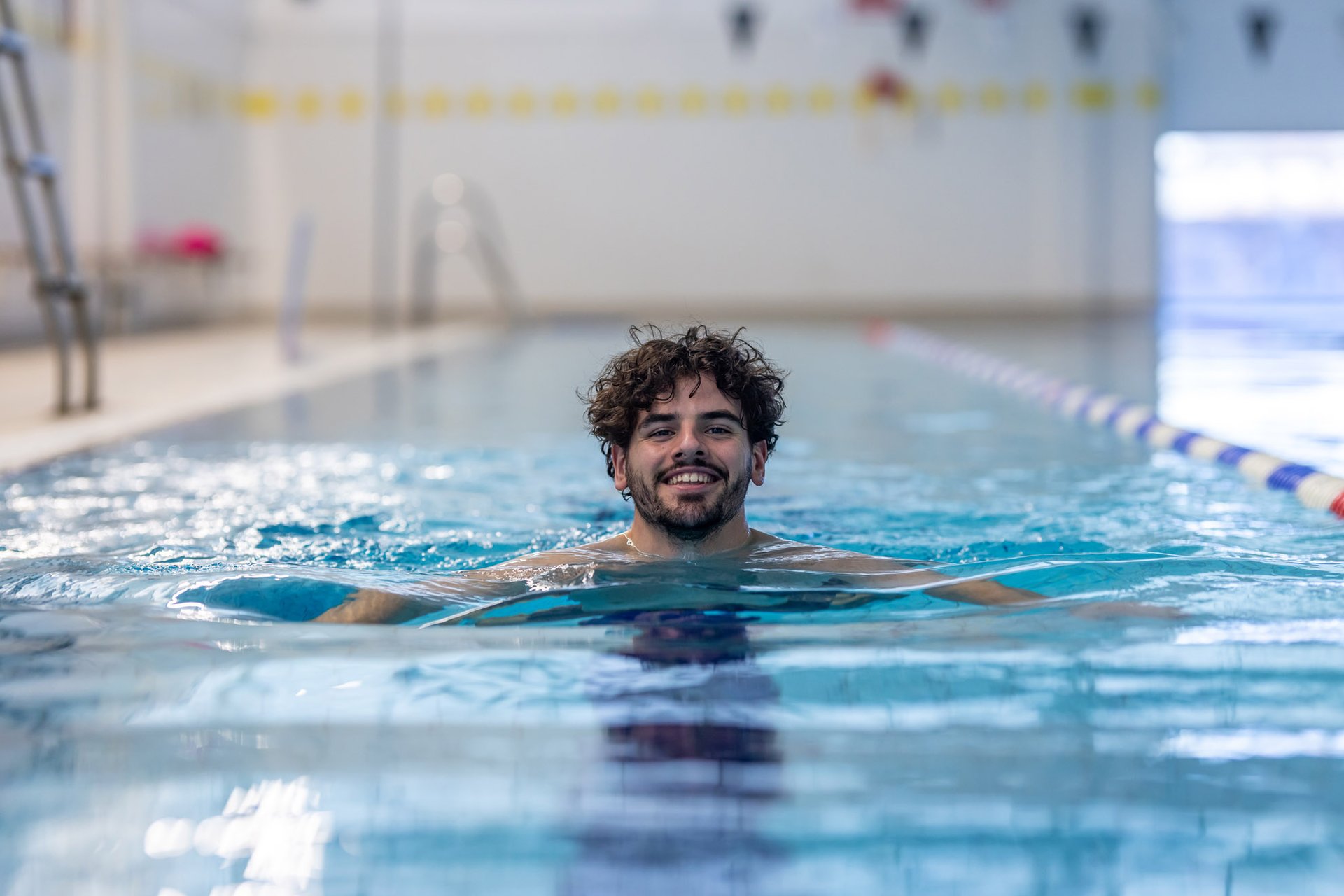 Young malemember swimming the breast stroke in the 25 meter 6 lane pool at Westwoods Health Club